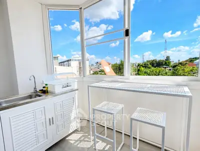 Bright balcony with white furniture and stunning city view