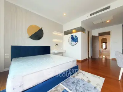 Spacious modern bedroom with stylish decor and wooden flooring