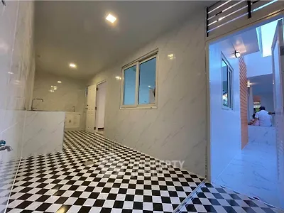 Modern tiled hallway with checkered floor and bright lighting