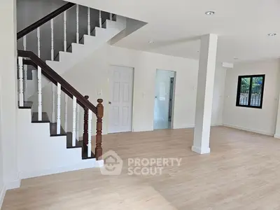 Spacious modern interior with elegant staircase and natural light