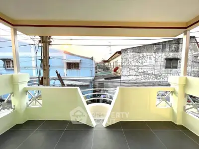 Spacious balcony with urban view, perfect for relaxation and enjoying city life.