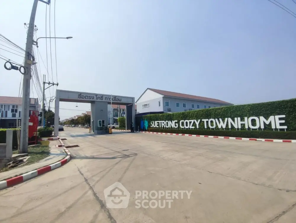 Modern townhome entrance with clear signage and well-maintained surroundings.