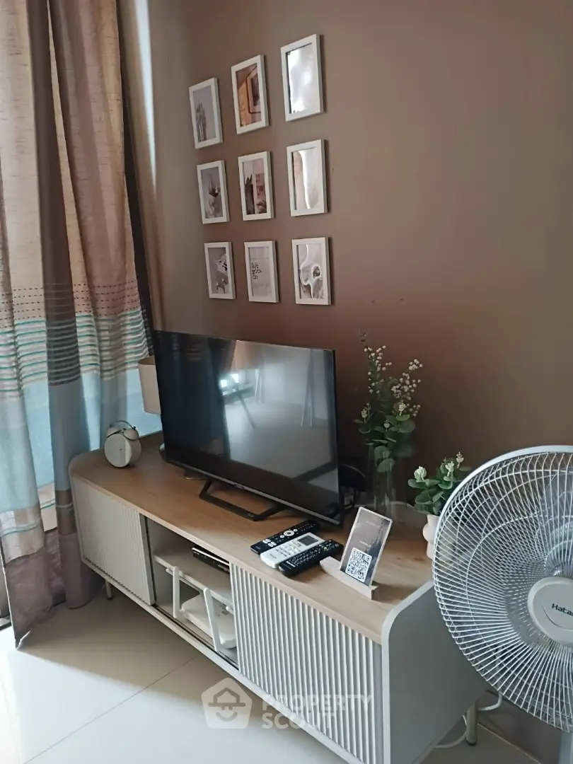 Cozy living room with modern TV stand and decor, perfect for relaxation.