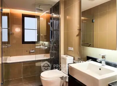 Modern bathroom with glass shower, bathtub, and sleek fixtures in a contemporary apartment.