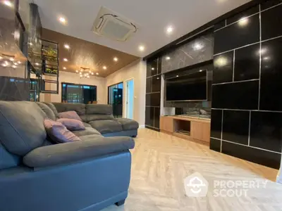 Luxurious modern living room with sleek black accents and spacious seating area