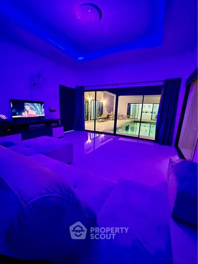 Luxurious living room with ambient lighting and pool view