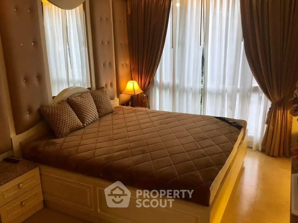 Luxurious bedroom with elegant decor and large windows for natural light.