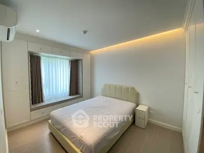 Modern bedroom with elegant lighting and built-in window seat