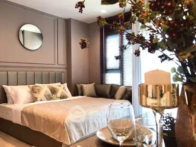 Luxurious bedroom with elegant decor and cozy ambiance, featuring plush bedding and stylish furnishings.