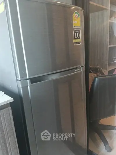 Modern kitchen with sleek stainless steel refrigerator and stylish cabinetry.