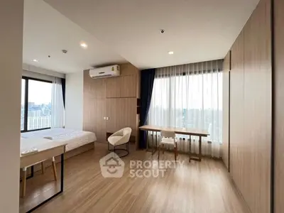 Spacious modern bedroom with city view and elegant wooden flooring