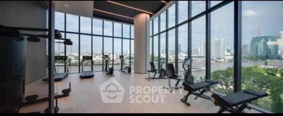 Luxurious gym with panoramic city view and modern equipment in high-rise building.