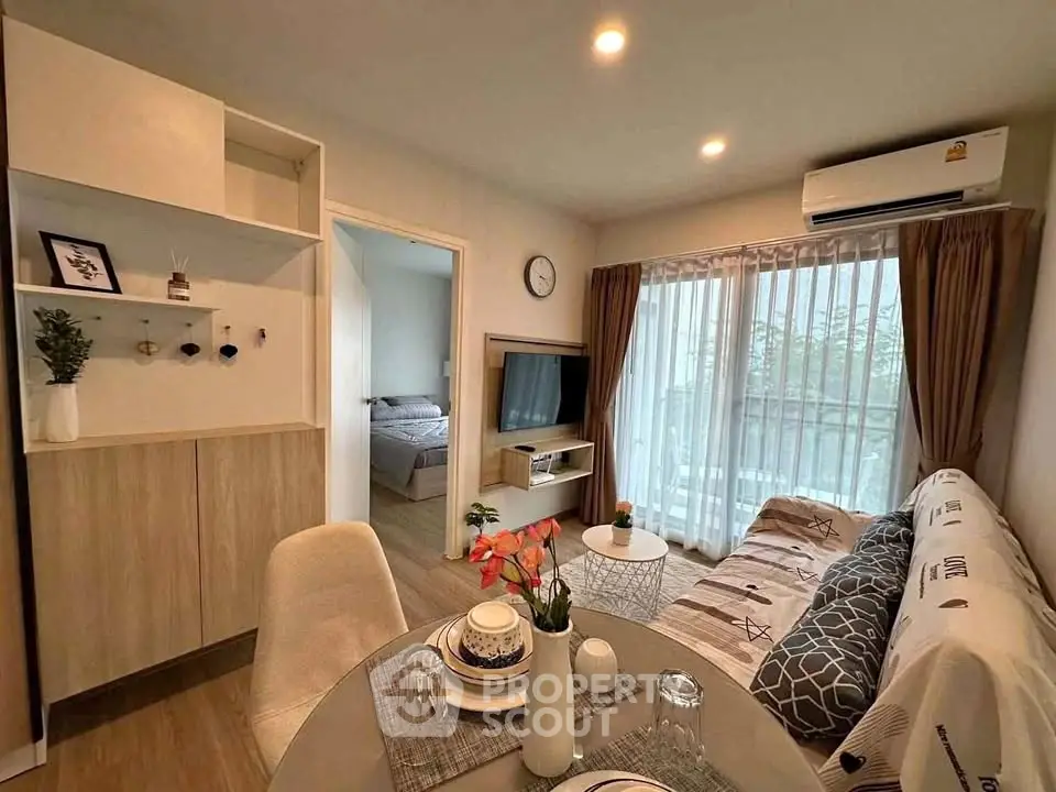 Modern living room with cozy dining area and balcony view