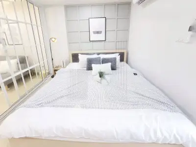 Modern bedroom with stylish decor and cozy ambiance in a contemporary apartment.
