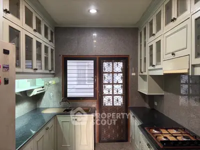 Spacious kitchen with gas stove and ample cabinetry in modern home