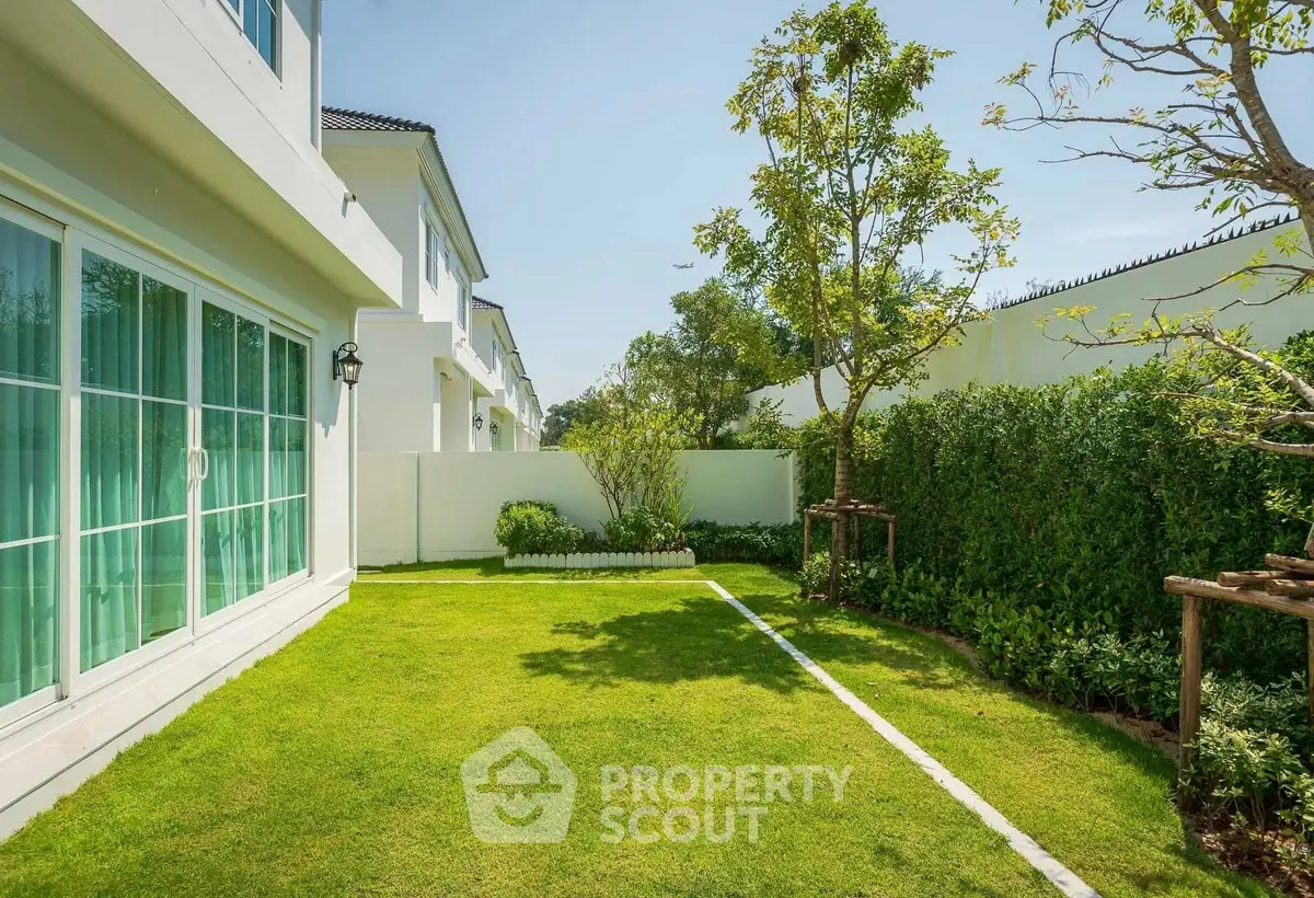 Beautiful garden view of modern home with lush green lawn and trees