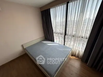 Bright bedroom with large window offering stunning city views