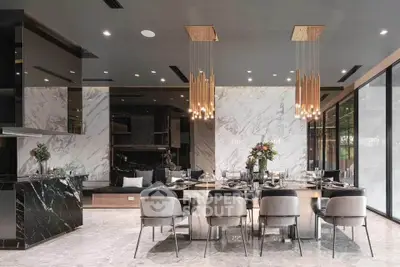 Luxurious dining room with elegant marble finishes and modern lighting fixtures.