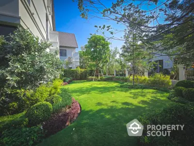 Luxurious garden view with lush greenery and modern architecture in a serene residential area.