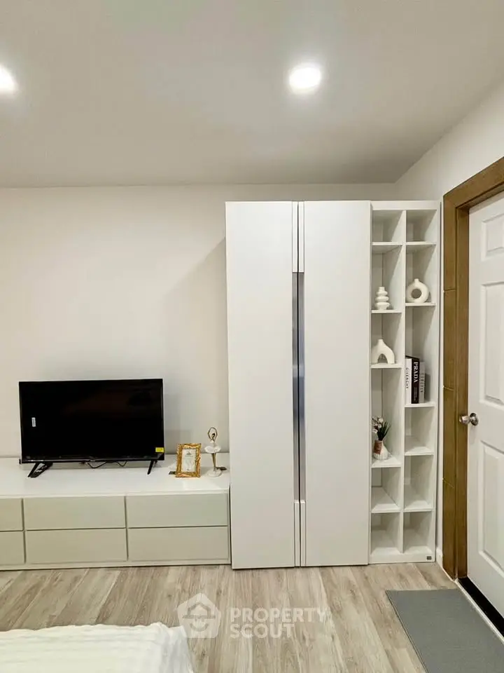Modern bedroom with sleek white furniture and stylish decor