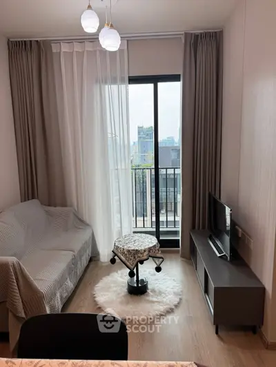 Cozy living room with city view, modern decor, and natural light.