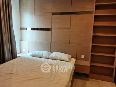 Cozy bedroom with modern wooden paneling and built-in shelves, perfect for a restful retreat.