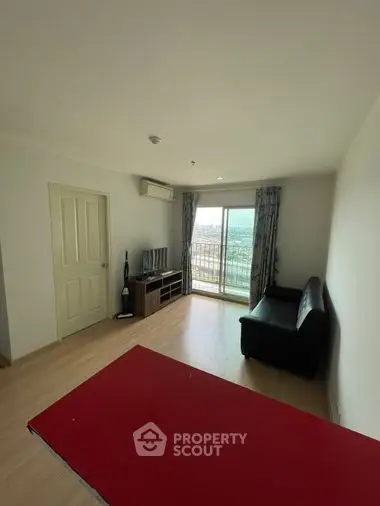 Spacious living room with abundant natural light, sleek flooring, and a breathtaking view through the large balcony doors, perfect for relaxation and entertainment.