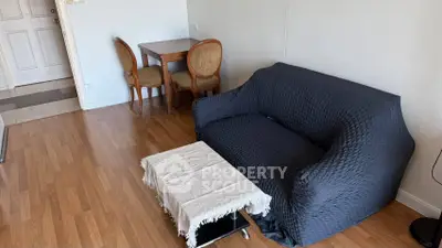 Cozy living room with elegant wooden flooring and stylish furniture, perfect for relaxation and entertaining.