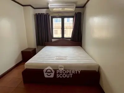 Cozy bedroom with air conditioning and natural light, perfect for restful nights.