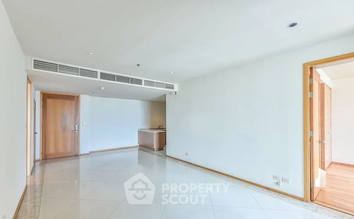 Spacious empty living room with modern tile flooring and wooden accents