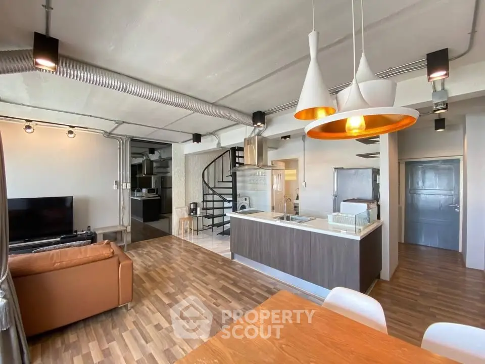 Modern open-plan living room with stylish kitchen and spiral staircase