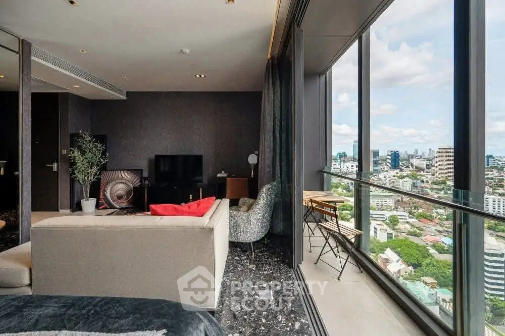Luxurious living room with stunning city view from high-rise balcony.