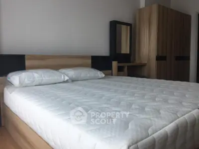 Modern bedroom with stylish wooden furniture and comfortable bed