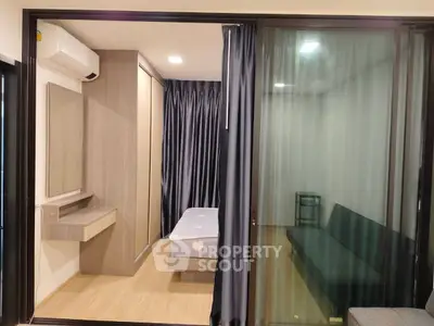 Modern bedroom with sliding glass doors and stylish furnishings