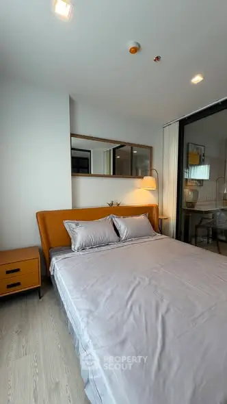 Modern bedroom with stylish decor and cozy ambiance in a contemporary apartment.