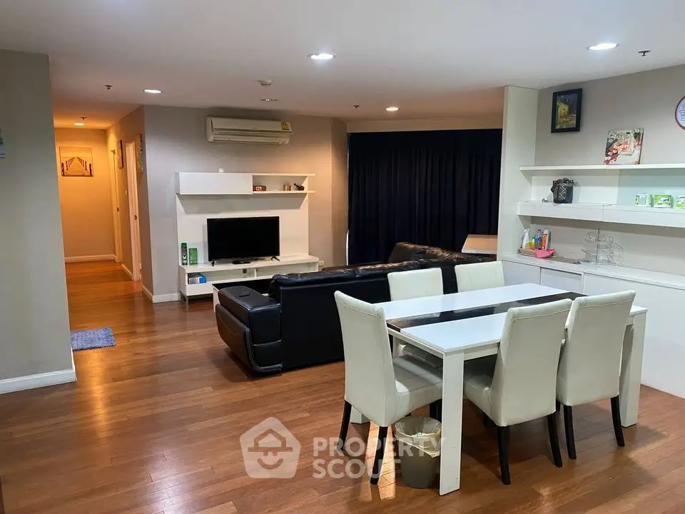 Spacious living room with modern dining area and cozy seating, perfect for family gatherings.