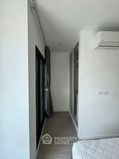 Modern bedroom with air conditioning and large window for natural light