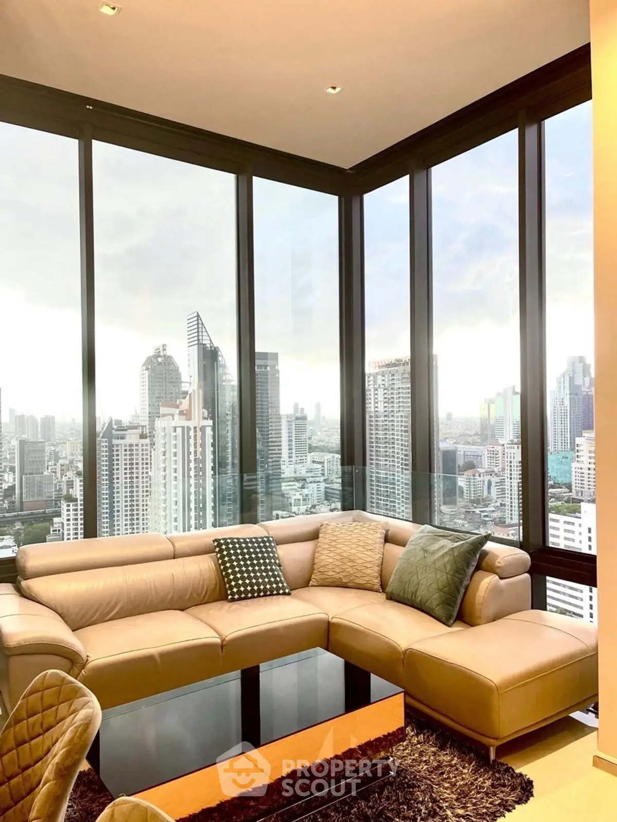 Luxurious corner living room with panoramic city views and modern leather sofa.