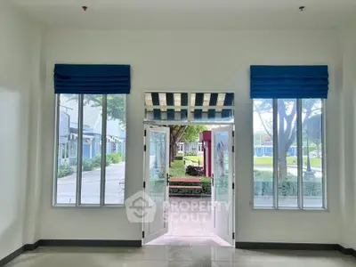 Spacious room with large windows and garden view, perfect for natural light lovers.