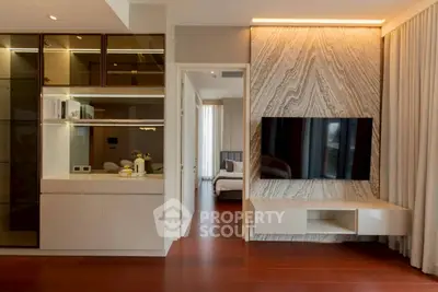 Modern living room with sleek TV setup and elegant wood flooring