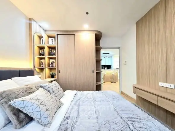 Modern bedroom with cozy decor and built-in storage in a stylish apartment.
