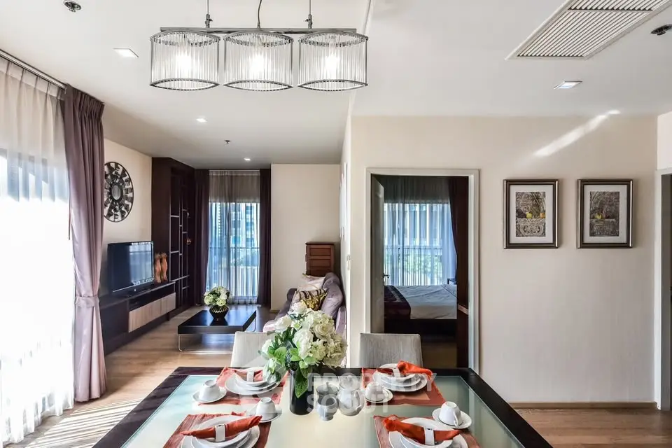 Elegant open-plan living and dining area with modern decor and natural light.