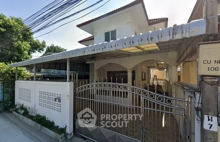 Charming two-story house with gated entrance and covered parking in a serene neighborhood.