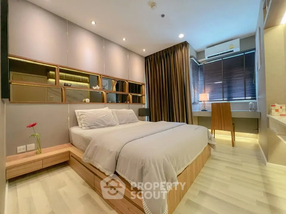 Modern bedroom with stylish decor and natural light, featuring a cozy bed and elegant furnishings.