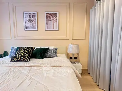 Elegant bedroom with stylish decor and cozy bedding in modern apartment.