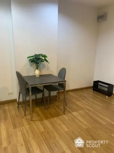 Minimalist dining area with wooden flooring and modern furniture