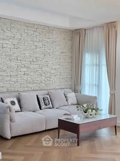 Stylish living room with textured stone wall and elegant decor