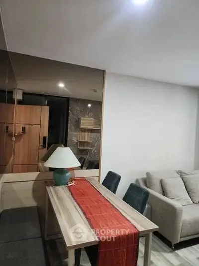 Modern living room with stylish dining area and cozy sofa, perfect for urban living.