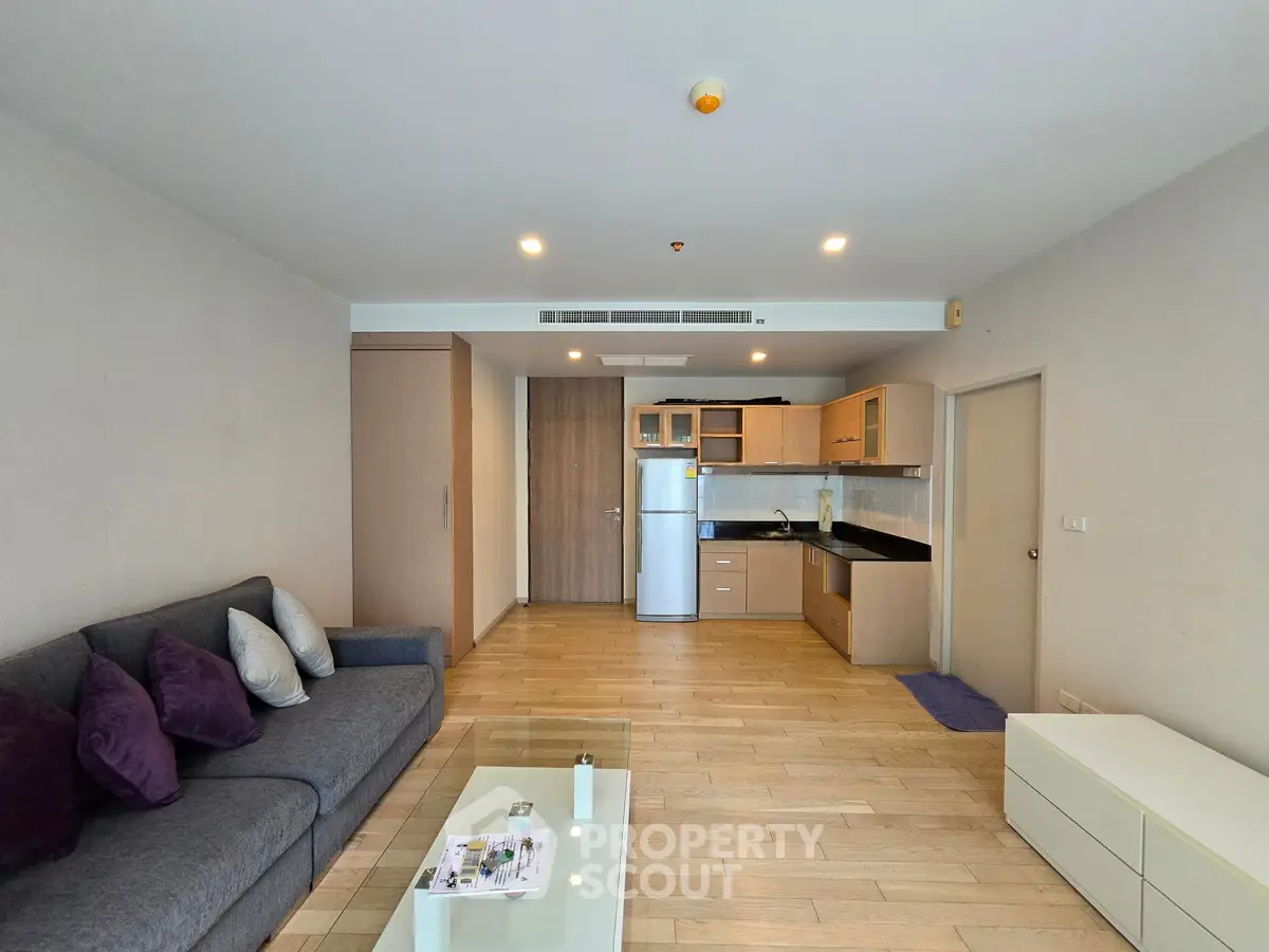 Spacious modern living room with open kitchen layout and stylish furnishings