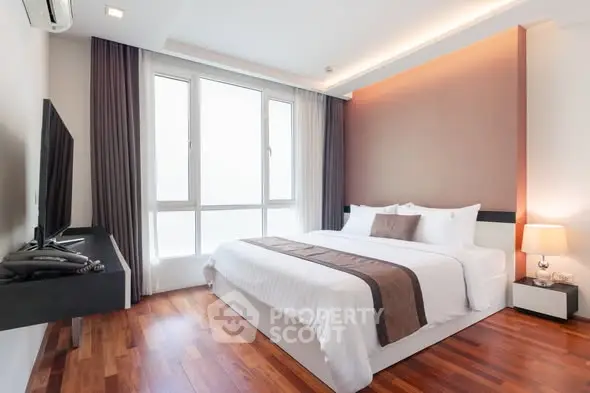 Spacious modern bedroom with large windows and elegant decor